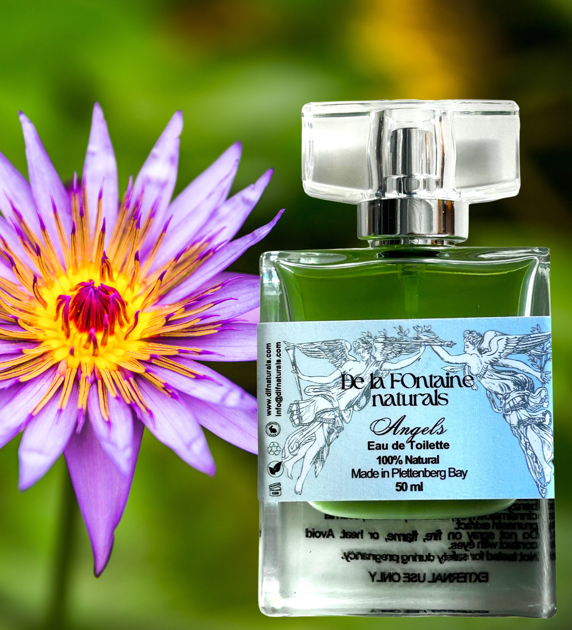 A clear bottle of De La Fontaine Angels Eau de Toilette with a label that showcases the brand and product name, placed next to a purple flower.