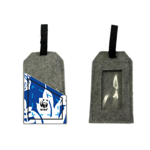 Two gray recycled plastic luggage tags with blue and white designs, one featuring a clear window for identification, the other with a dark strap.
